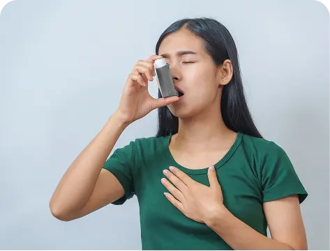 a woman with asthma using an inhaler to breathe better