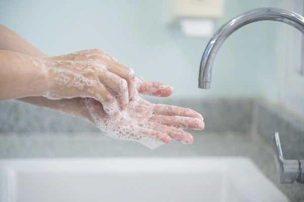Hands lathering with soap to help prevent flu and reduce risk of asthma attacks